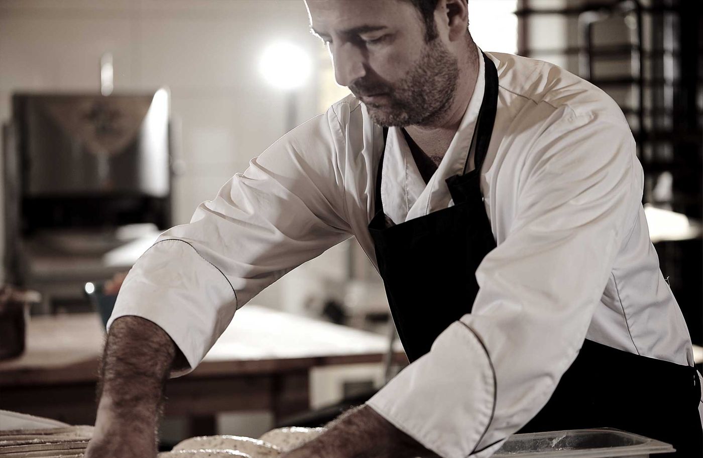 A baker shaping dough at Borgeby Stenugnsbageri