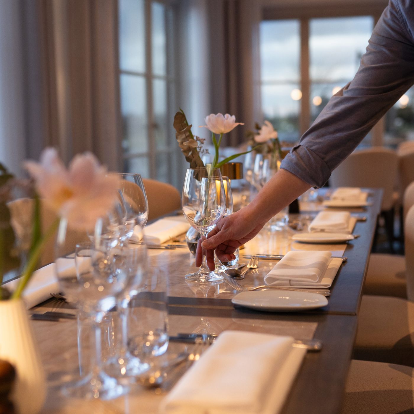A table being set in the dining room at Flädie Mat & Vingård