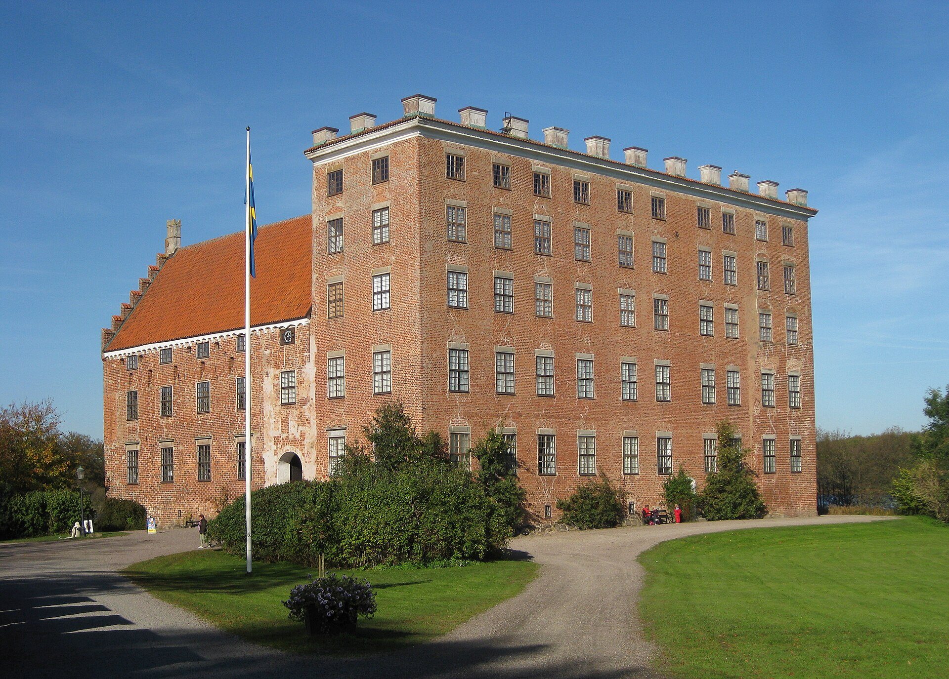 De høje teglmure på Svaneholms slott ved søen i Skurup
